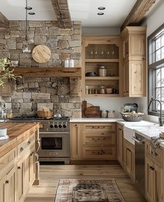 a kitchen with wooden cabinets and stone wall above the stove, along with an area rug on the floor