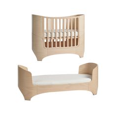 two wooden cribs, one with a mattress and the other without bedding