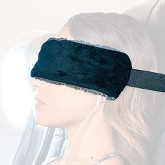 a woman wearing a blindfold and headphones