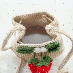 a crocheted strawberries purse is sitting on a table