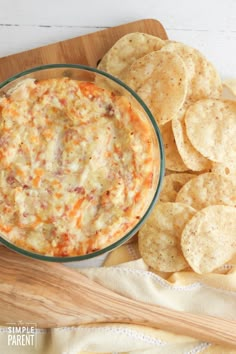 a bowl of dip with tortilla chips on the side