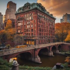 an old brick building with a bridge crossing over it in the middle of a city