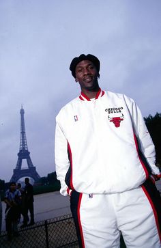 a man standing in front of the eiffel tower