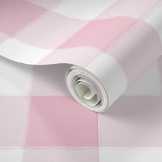 a pink and white checkered wallpaper with a roll of paper on top of it