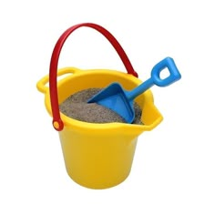 a toy shovel and sand in a yellow bucket