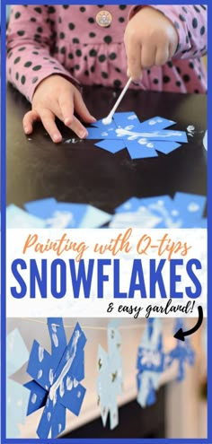 a child is painting snowflakes with blue paint and paper on the table,