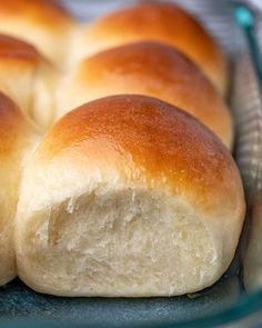 a loaf of white bread sitting on top of a glass pan filled with it's crust