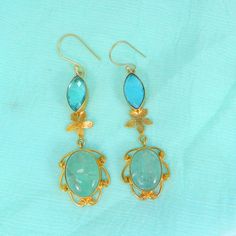 Sky Blue Topaz Earrings- Aqua Crackle Glass Gemstone Earrings- Gold Plated Drop Earrings- Topaz Jewelry- Fashion Earrings for Women Description : Metal : Brass Plating : Gold Plated Stone : Sky Blue Topaz Hydro and Aqua Crackle Glass Length : 70 x 17 mm Approx Weight : 11.46 Gram Approx Stone Size : 16 x 7 mm approx marquise topaz, 17 x 13 mm approx oval crackle glass ❣❣ Handmade Item ❣❣ **Made to Order** » G EM S T O N E D E T A I L « **Gemstone structure may vary from the image as two gemstone Handmade Blue Drop Earrings, Blue Elegant Handmade Danglers, Handmade Blue Elegant Danglers, Elegant Turquoise Danglers As A Gift, Elegant Turquoise Danglers For Gift, Blue Danglers For Gift, Dangle Earrings Gold, Gemstone Earrings Gold, Topaz Jewelry