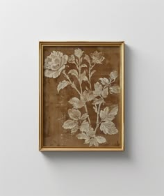 a painting hanging on the wall with a gold frame and flowers painted on it's side