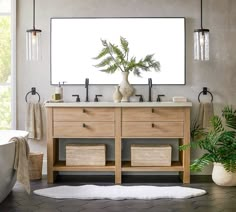 a bathroom with two sinks and a large mirror on the wall next to a bathtub