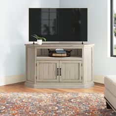 a flat screen tv sitting on top of a wooden cabinet