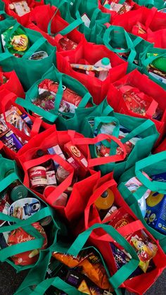 many red and green bags filled with food on top of a floor next to each other