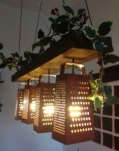 some lights are hanging from the ceiling in front of potted plants and other items