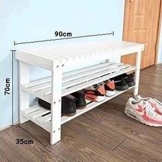 a white shoe rack with shoes on the floor next to it and measurements for each pair