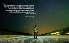 a man standing on top of a snow covered field under a sky filled with stars