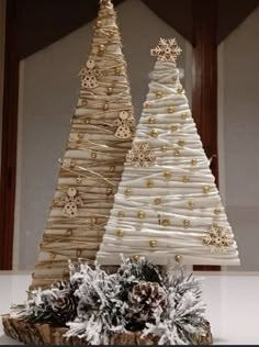 two small christmas trees made out of burlocks