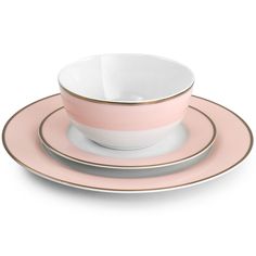 a pink and white cup with two plates on it