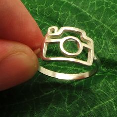 Silver Camera Ring is handmade with its own uniqueness. It can be bought as a gift for any occasion like birthday gift, wedding gift, travel gift, souvenir and etc. If you need rose gold plating or yellow gold plating, please contact us, we will advice you on the additional fees applicable. Base Material: Sterling Silver Size: 14mm X 10mm (Approximately) Ring Size: US 4 - US 14 (Please sellect your size) Metal Stamped: 925 Crafting Time: 7 - 10 working days Thickness: 1.5mm / 0.059 Inch You'll r Camera Jewelry, Dslr Quotes, Dslr Bag, Dslr Backpack, Canon Camera Models, Travel Ring, Ring Camera, Dslr Photography Tips, Clay Silver