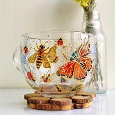 a glass cup sitting on top of a wooden coaster