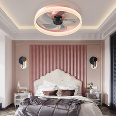 a bedroom with pink walls and white bedding has a fan on the headboard