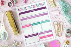 the goal setting worksheet is surrounded by office supplies and paper clips on a pink background