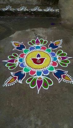 a colorful flower design painted on the ground