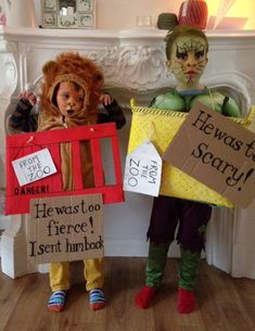 two children dressed in costumes holding signs that say he was scary and he was too fierce