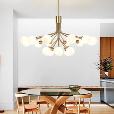 a modern chandelier hangs over a dining room table