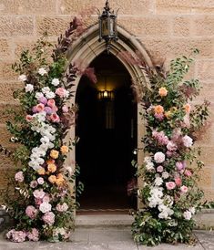 an entrance to a building with flowers on it