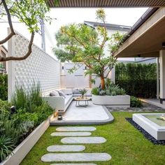 an outdoor living area with grass and stepping stones