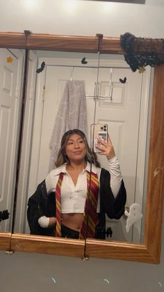 a woman taking a selfie in front of a mirror wearing a harry potter costume