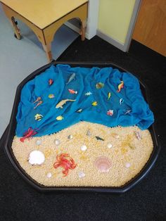 the sand is covered with sea animals and other things to play with in the sand