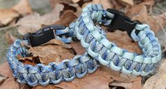 two blue and white paracorine bracelets on leaves in the woods, one with black buckle