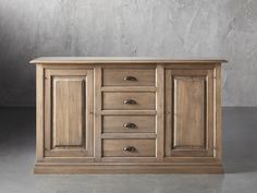 a large wooden cabinet sitting on top of a cement floor