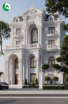 a large white building with lots of windows and balconies on the top floor