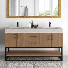 a bathroom vanity with two sinks and a large mirror on the wall above it, along with a rug