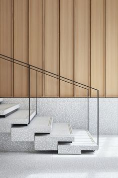 the stairs are made from concrete and have metal railings on them, along with wood paneling