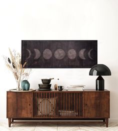 a sideboard with some vases and other items on it