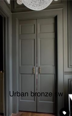 an open door with the words urban bronze swag on it in front of a chandelier