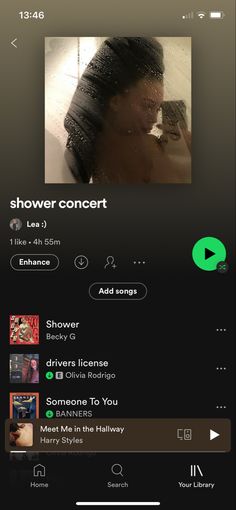 an iphone screen showing the music player for shower concert on it's playlist