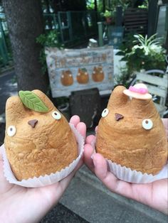 two people are holding some food in their hands