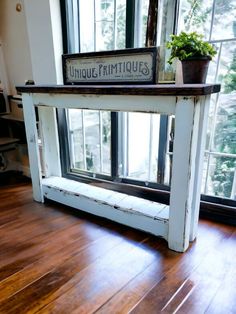 an old window sill with a sign on it that says unique furnitures in front of a large window