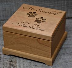 a small wooden box with a dog's paw print on the front and bottom