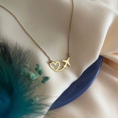 Heart and Airplane Necklace - Heart Flying Necklace - Gift for Travel Lover - Gift for Pilot - Stewardess Gift - Traveler's Necklace - Modern Jewelry - Best Friend Gift's - Valentine's Day Gift Introducing our Heart and Airplane Necklace, the perfect gift for pilots or a delightful hostess gift. This exquisite necklace combines elegance with a touch of wanderlust, making it a unique and thoughtful present for aviation enthusiasts or those who love to travel. Material - High Quality Handmade 925 Sterling Silver - 18K Gold Plated and 18K Rose Plated - High Quality Handmade 8K REAL GOLD and 14K REAL GOLD - 8K & 14K REAL ROSE GOLD and 8K & 14K REAL WHITE GOLD Preparation and Shipping : - The processing time of all our products is 3-5 working days. - You can send us a message for fast shipping Pilot Necklace, Pilot Jewelry, Gifts For Pilot, Aviation Jewelry, Airplane Jewelry, Necklace Photography, Airplane Necklace, Student Pilot, Fondant Rose