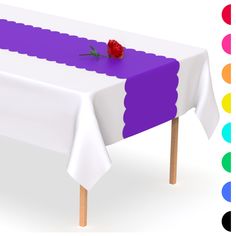 a table with a single rose on it and colored circles around the table behind it