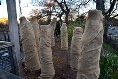 there are many bags wrapped in burlock to look like human figures on the street