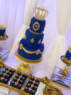 three tiered blue cake with gold decorations