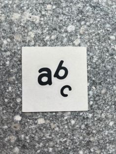 a piece of paper with the word abc written in black ink on top of it