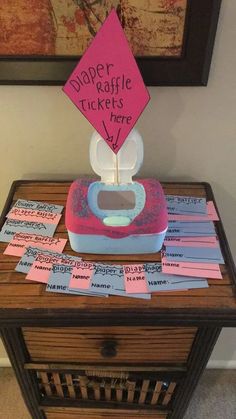 a table topped with lots of pink and blue paper on top of a wooden table