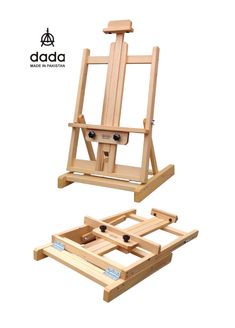 a wooden easel sitting on top of a white floor next to an open box